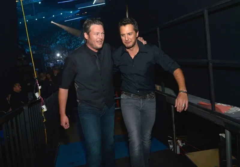 Blake Shelton and Luke Bryan walk off stage, 2013